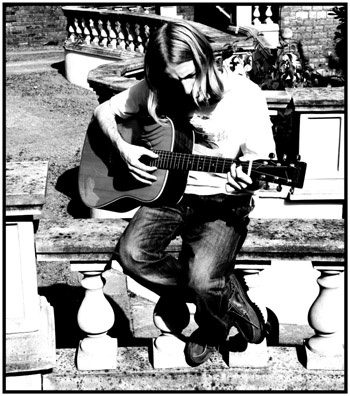 Open Amaj7, very nice... - Photo by Andy Brotherton John playing guitar